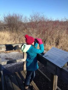 photos of child with binoculars in winter clothes