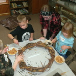 This was a favorite "messy" activity for the Budding Birders. They smeared peanut butter on the wreath and then sprinkled it seed. 