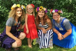 Photo of young girl and ladies dressed in flower crowns