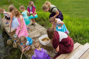 photo of kids and teacher learning about pond life