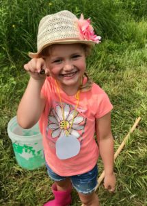 Summer camper holding a pond critter