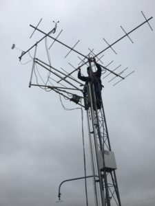 photo of man putting up motus antenna