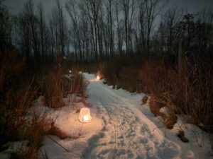 photo of candlelit trail in winter